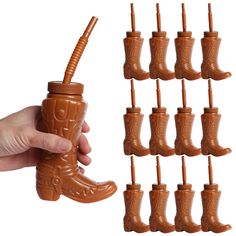 a hand is holding a chocolate cup with many cups in the shape of cowboy boots