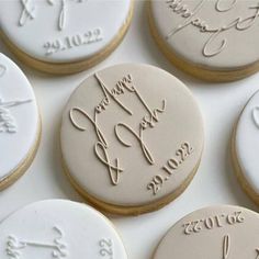 decorated cookies with names and date written on the top one cookie is for someone's special day