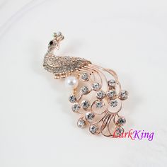 "LarkKing BH93 Peacock brooch, crystal peacock brooch, pearl peacock brooch, rhinestone peacock brooch, women gift, birthday gift. Material: brass metal, rhinestone crystals, pearl Size: 2 3/4\"x 1 3/8\" (width x height) Weight: 15.1 g (0.53OZ) Gift box is available at https://www.etsy.com/your/shops/LarkKing/tools/listings/section:22684027 LarkKing Sweet and sleek! All that jewelry. Meet the owner of LarkKing Learn more about the shop and process" Elegant Peacock Design Brooch For Formal Occasions, Elegant Peacock Design Brooch For Formal Wear, Peacock Colored Wedding Brooch Jewelry, Elegant Party Brooch With Peacock Design, Elegant Peacock-colored Brooches For Wedding, Elegant Peacock Brooches For Wedding, Gold Brooches With Peacock Design As Gift, Elegant Peacock Color Party Brooches, Elegant Peacock Color Wedding Brooches