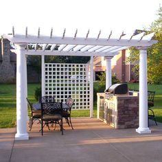 an outdoor grill and table with chairs