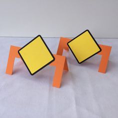 two orange and yellow square shaped objects sitting on top of each other