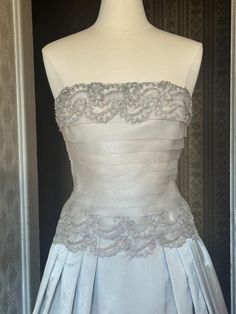 a white wedding dress on display in a room