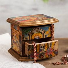 a small wooden box sitting on top of a table next to a cross and rosary