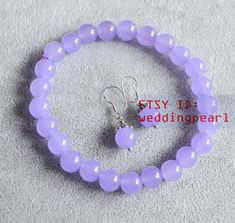 jewelry: lilac jade stretch bracelet and dangling earrings agate colour: lilac agate Diameter: 8mm agate body: AA+ agate luster: high agate shape: round bracelet length: choose,( For example: 6 inches wrist measure size ,please choose 7 inches bracelet ,and so on.) Clasp: without clasp the earrings with sterling silver hook Packing:Beautiful Pouch Click on the image(s) for larger view If you want to order of different style. Please feel free contact me . Thank you . Purple Beaded Bracelets, Pink Jade, Jade Earrings, Jade Bracelet, Wedding Jewelry Sets, Kids Jewelry, Bead Bracelet, Stretch Bracelet, Earrings Set