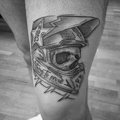 a black and white photo of a man's leg with a tattoo on it