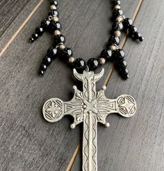 This beautiful, one-of-a-kind pewter ornate cross necklace will inspire all your moonlit nights. Handmade with black agate and glass beads. Measures 18 inches long and has a 2 inch extender chain. product details silver tone metals; Cross is soft pewter. 18 inches long with 2 inch extender black agate and glass beads VISIT MY SHOPS HERE * http://www.etsy.com/shop/HappyCatHouse * http://www.Etsy.com/shop/AnEnchantingCreature CONNECT * http://www.facebook.com/EnchantingCreature * https://www.insta Medieval Style Metal Necklaces For Larp, Black Adjustable Crucifix Necklace, Adjustable Black Crucifix Necklace, Silver Cross Jewelry With Black Beads, Adjustable Cross Necklace With Black Beads, Adjustable Black Beads Cross Necklace, Spiritual Metal Cross Necklaces, Gothic Cross Necklace For Festivals, Gothic Black Metal Cross Necklace