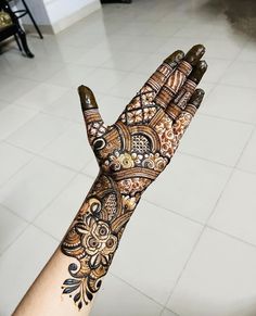 a person's hand with henna tattoos on it