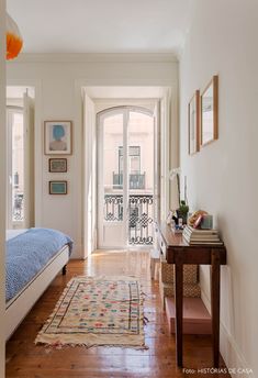 a bedroom with hardwood floors and white walls has a blue bed spread on the floor