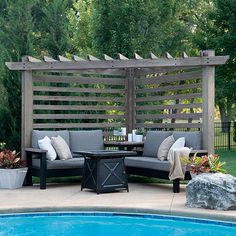 an outdoor seating area next to a swimming pool