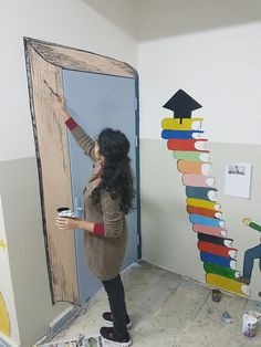 a woman is painting the door to her room