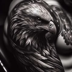 a black and white photo of an eagle tattoo on someone's arm or leg