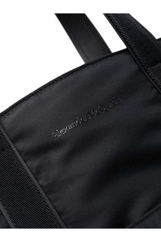 Black leather/fabric logo-embroidered tote from Alexander McQueen featuring embroidered logo to the front and two shoulder straps..Black.100% Calf Leather.Italy.Tote bag.Logo embroidered.Two shoulder straps.Black.Leather with fabric lining Designer Shoulder Bag With Embroidered Logo For Everyday, Double Handle Bags With Logo Strap For Shopping, Shopping Bags With Logo Strap And Double Handle, Luxury Daily Use Bags With Adjustable Straps, Designer Tote Bag With Embroidered Logo, Luxury Tote Bag With Embroidered Logo, Leather Shoulder Bag With Embroidered Logo For Daily Use, Leather Shoulder Bag With Embroidered Logo For Everyday Use, Everyday Leather Shoulder Bag With Embroidered Logo