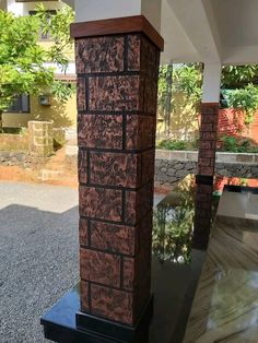 a tall brick pillar sitting on top of a black table