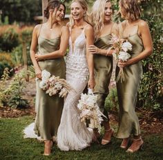 four bridesmaids in green dresses posing for the camera