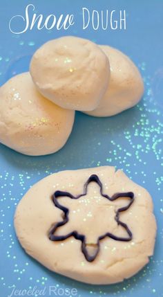 two snow dough cookies with icing on a blue background and text overlay that reads, snow dough