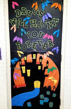 a door decorated with halloween decorations and writing