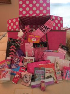 a pink and white polka dot box filled with lots of items