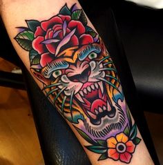 a colorful tiger with roses on his head and eyes is shown in this tattoo design