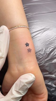 a person with a small clover tattoo on their foot