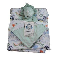 a baby blanket with a stuffed animal on it's back and the name gerber