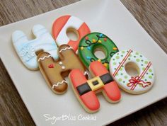 decorated cookies are arranged on a white plate