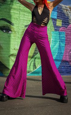 The Pink & Black Stripe Big Bells are your go-to stylish everyday pant. Dress these flattering pants up or down- truly perfect for almost any occasion. Design Features: High waistband hits comfortably at your true waist Waistband can be rolled down to expose belly Perfectly hugs hips Pant leg flares into large bells Fantastic garment to dress up and down. Incredibly vibrant print. Made in San Francisco, CA, USA Fabric Features: Radical vertical Pink and Black stripe. Moisture Wik Polyester/Spand High Waist Yoga Pants With 4-way Stretch For Spring, Chic Pants With Wide Waistband For Spring, Black 4-way Stretch Bottoms For Spring, Chic Yoga Pants With 4-way Stretch, Versatile Stretch Pants For Spring, Trendy Wide Leg Yoga Pants, Chic Fitted Wide Leg Pants With Wide Waistband, Non-stretch Hip-length Bottoms For Night Out, Chic Summer Yoga Bottoms