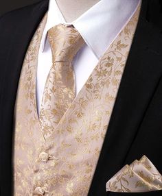 a man in a suit and tie is wearing a black jacket with gold flowers on it