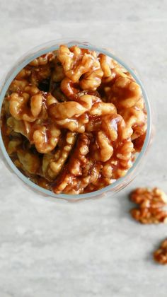 walnuts are in a glass bowl on the table