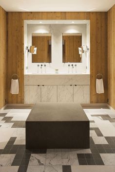 a large bathroom with two sinks and mirrors