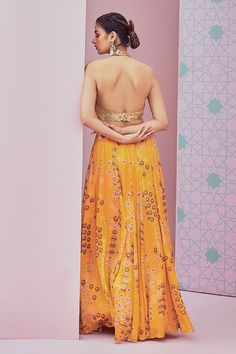 Yellow panelled lehenga featuring all over jhumka patterns. Comes with sequin embellished halter neck padded blouse.
Components: 2
Pattern: Embroidered
Type Of Work: Sequin
Neckline: Halter neck
Sleeve Type: Sleeveless
Fabric: Lehenga: Modal satin, Blouse: Georgette
Color: Yellow
Other Details: 
Cut-out blouse hem
Front hook blouse closure
Panelled lehenga skirt
Length (in inches): 45
Occasion: Sangeet,Cocktail - Aza Fashions Panelled Lehenga, Sequin Lehenga, Yellow Lehenga, Padded Blouse, Lehenga Skirt, Embellished Blouse, Hem Blouse, Blouse For Women, Satin Blouse