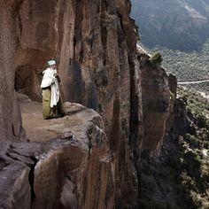 a man standing at the edge of a cliff