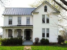 a large white house with a black roof