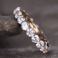 a diamond ring sitting on top of a rock