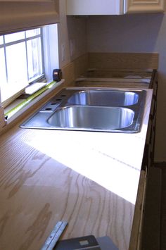 a kitchen counter with a sink and window in it