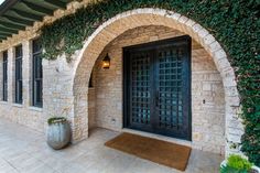 an entrance to a home with stone walls and doors