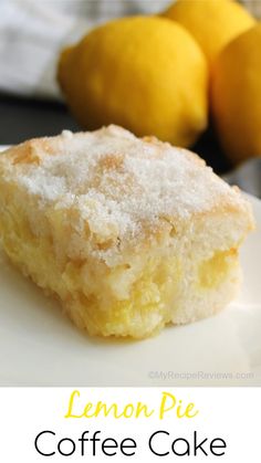 a close up of a piece of cake on a plate with lemons in the background