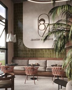 the interior of a bakery and coffee shop with palm trees in the foreground, potted plant on the far wall