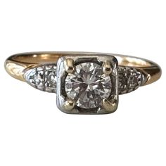 an antique diamond ring with two tone gold accents