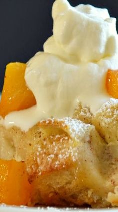 a piece of cake with whipped cream and oranges on top is sitting on a plate