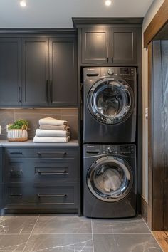 a washer and dryer sitting in a kitchen next to each other on top of cabinets