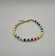 Colourful and stylish this rainbow pearl beaded bracelet is the perfect accessory to match the rainbow pearl beaded necklace. Made with seed beads and faux pearls. Length 6 inches and 1 inch extension chain. Adjustable Multicolor Pearl Bracelet, Adjustable Multicolor Pearl Chain Jewelry, Adjustable Multicolor Pearl Beaded Bracelet, Rainbow Pearl Charm Jewelry, Rainbow Pearl Jewelry With Pearl Charm, Multicolor Pearl Beaded Bracelets, Trendy Pearl Beaded Bracelets With Colorful Beads, Multicolor Pearl Jewelry With Letter Beads, Trendy Multicolor Pearl Bracelet With Colorful Beads