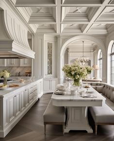 a large kitchen with white cabinets and an island in front of the stove top oven