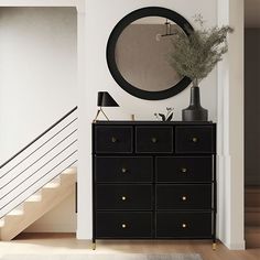 a black dresser sitting next to a staircase