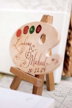 a small wooden easel with a painted pig on it's back and name