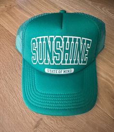 Embrace that laid-back, sunny vibe with this 'Sunshine State of Mind' Trucker Hat. This trendy piece is not just an accessory, but a statement of your love for open roads and clear skies. This green trucker hat features an adjustable snapback for maximum comfort and a perfect fit.   It's the perfect hat to remind you of sunny days and good vibes no matter where you are or what the weather is.  Flash this hat for your next trip or outdoor adventure! tag us @rowdiethreads Sunshine State of Mind | Trucker hat | Summer Hat | Summer Trucker Hat | Summer Trucker hat Summer Trucker Hat, Green Trucker Hat, Sunshine State Of Mind, Open Roads, Green Cap, Hat Summer, Summer Hat, Sunshine State, State Of Mind