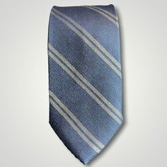 The textured woven silk of this blue denim tie is perfect for all seasons. The texture goes well with wool flannels, plaids and interesting mini checks. Made from 100% silk, the denim blue necktie combines well with pure white for that contrast or a pale grey to bring out the double charcoal stripe in the tie. Dapper Blue Ties For Workwear, Classic Blue Neckwear For Business, Classic Blue Business Neckwear, Classic Blue Neckwear For Semi-formal Occasions, Classic Blue Neckwear For Office, Classic Blue Suit And Tie Accessories For Business Casual, Purple Texture, Denim Tie, Blue Necktie