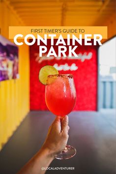 a hand holding up a drink with the text first timers guide to container park