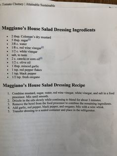 a menu listing the ingredients and instructions for a house salad dressing recipe on a wooden table