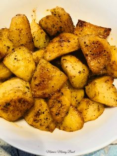 a white plate topped with potatoes covered in seasoning