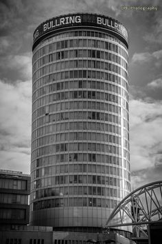 black and white photograph of the building in front of an overcast sky with clouds